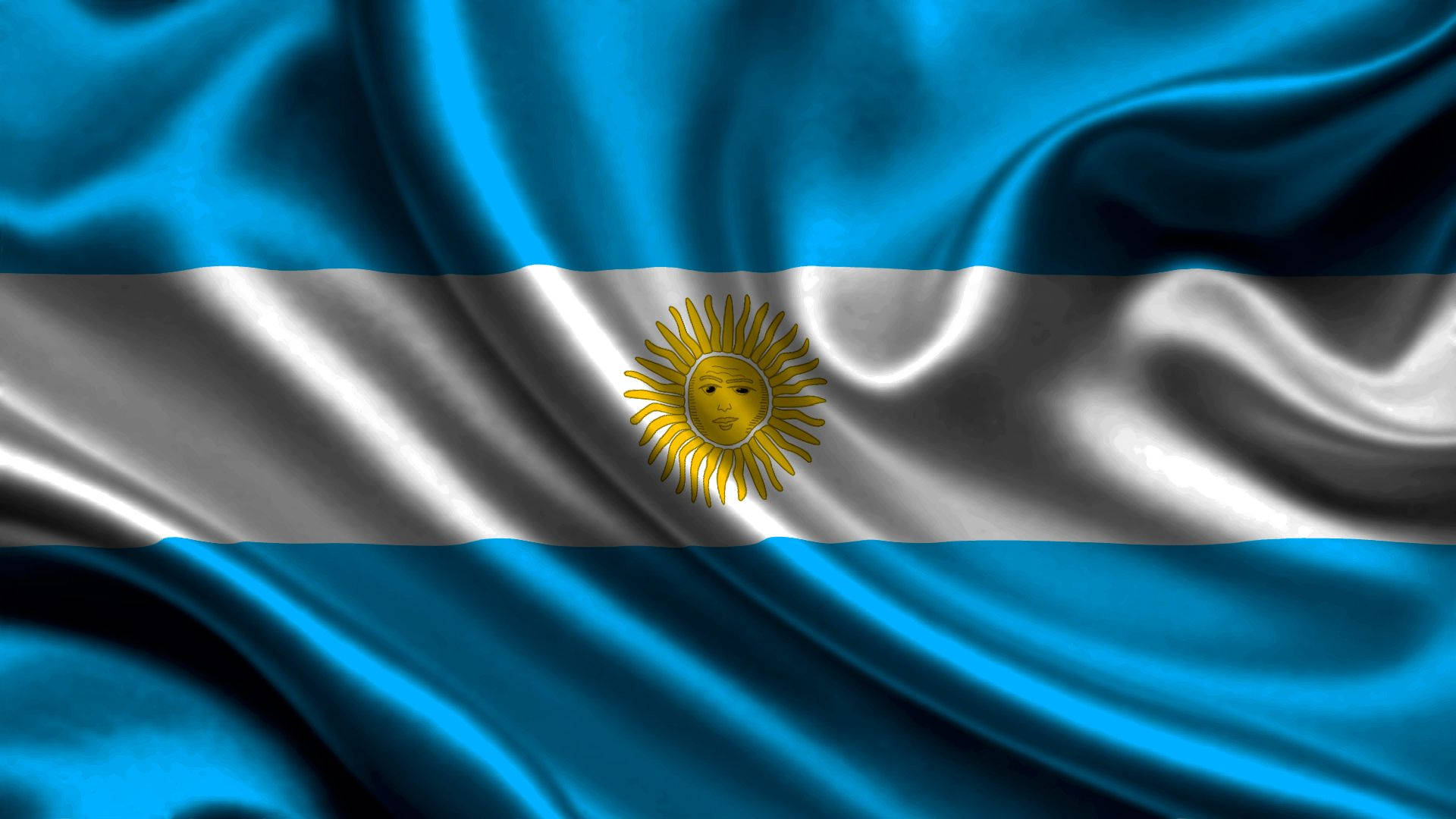 Argentina 桌布 壁紙 — 阿根廷國旗動態飄揚，帶有豐富的藍白條紋和燦爛的金色太陽標誌。