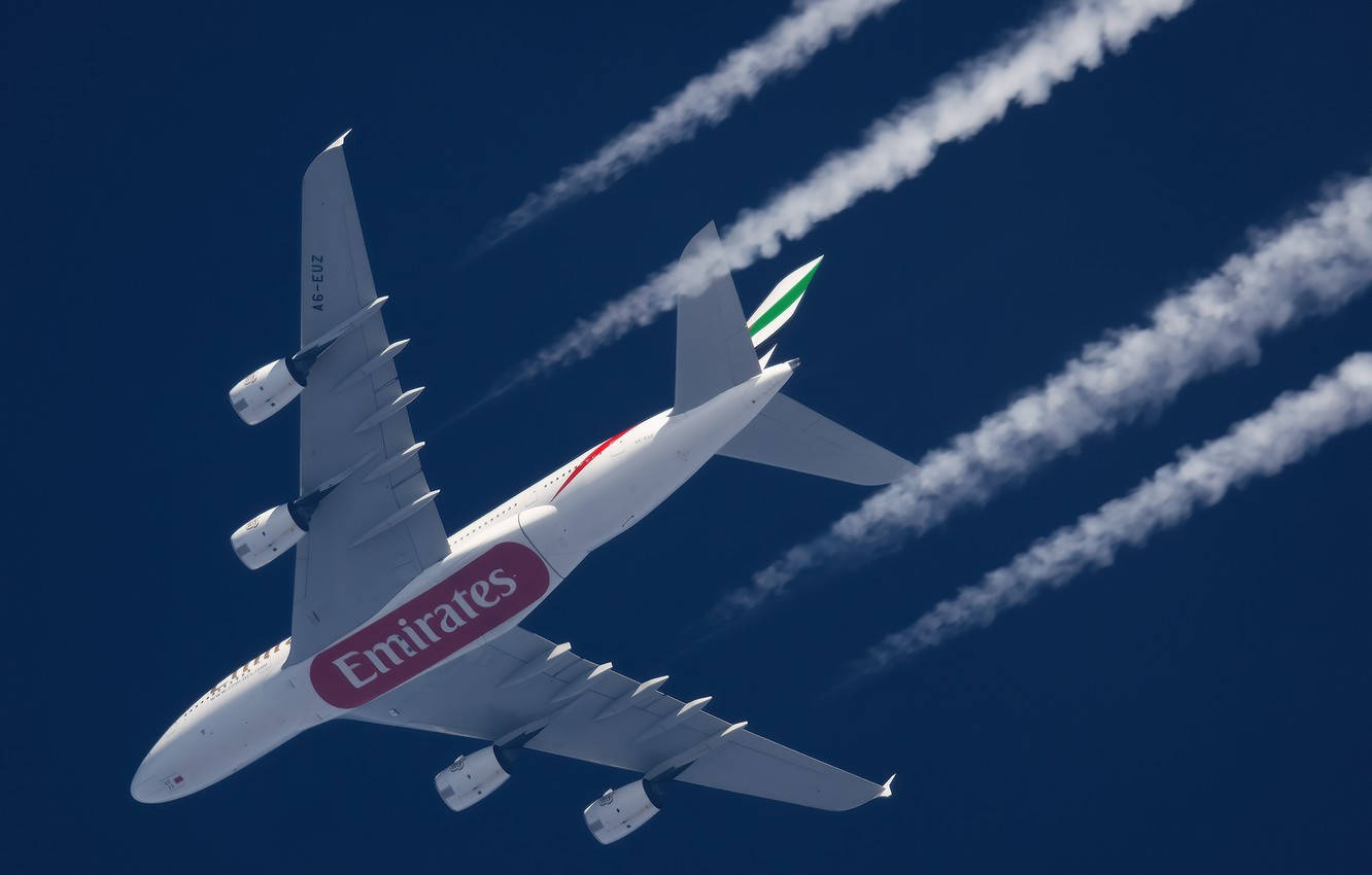 飛機 桌布 壁紙 — 阿聯酋航空的空中巴士A380在深藍色的天空中翱翔，留下厚厚的白色凝結尾跡。