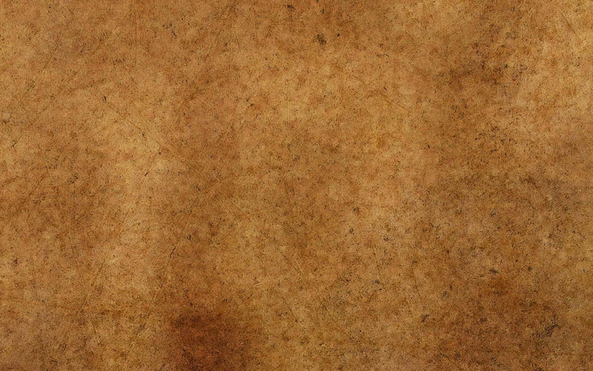 Brown Paper 桌布 壁紙 — 陳年棕色紙張的特寫，帶有細微紋理和變色斑點。