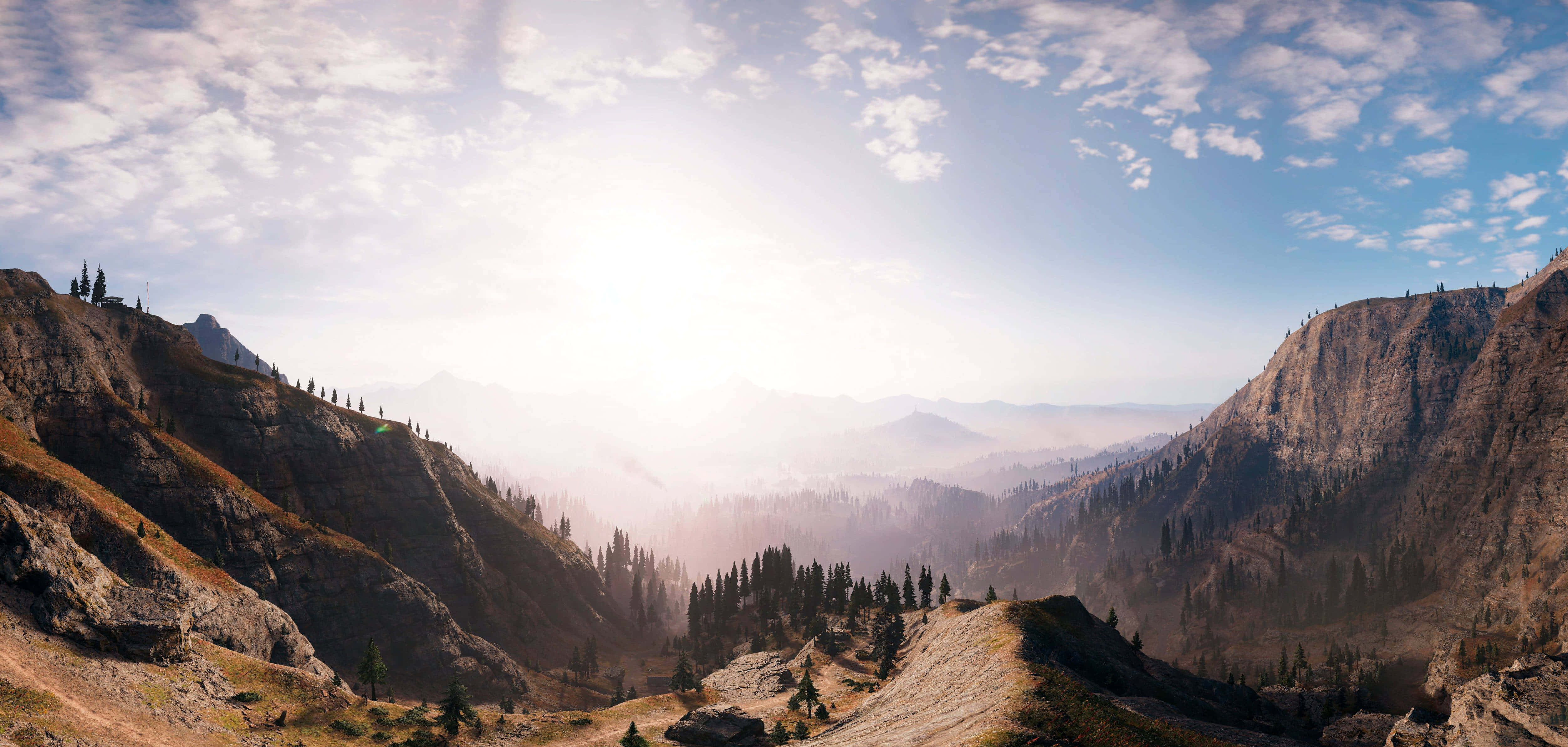Far Cry 桌布 壁紙 — 陽光灑落在一個廣闊的山谷中，山谷裡有岩石斜坡和散落的常綠樹，天空部分多雲。
