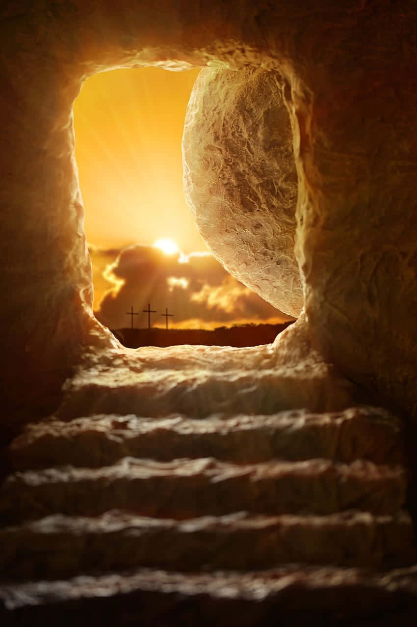 Empty Tomb 桌布 壁紙 — 陽光穿過石墓入口，顯露出日落時分有十字架的山丘。