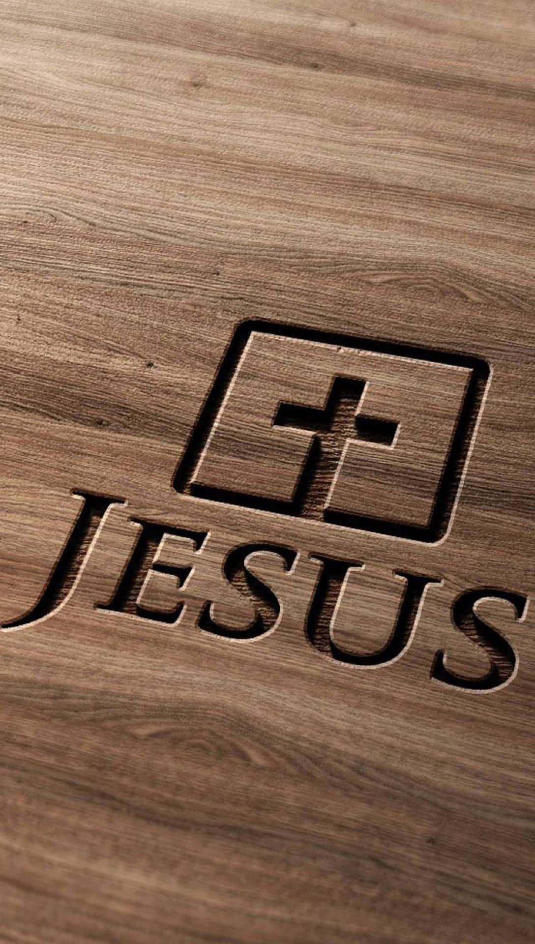 Jesus iPhone 桌布 壁紙 — 雕刻木質表面以質樸、帶紋理的設計呈現「JESUS」字樣和十字架標誌。