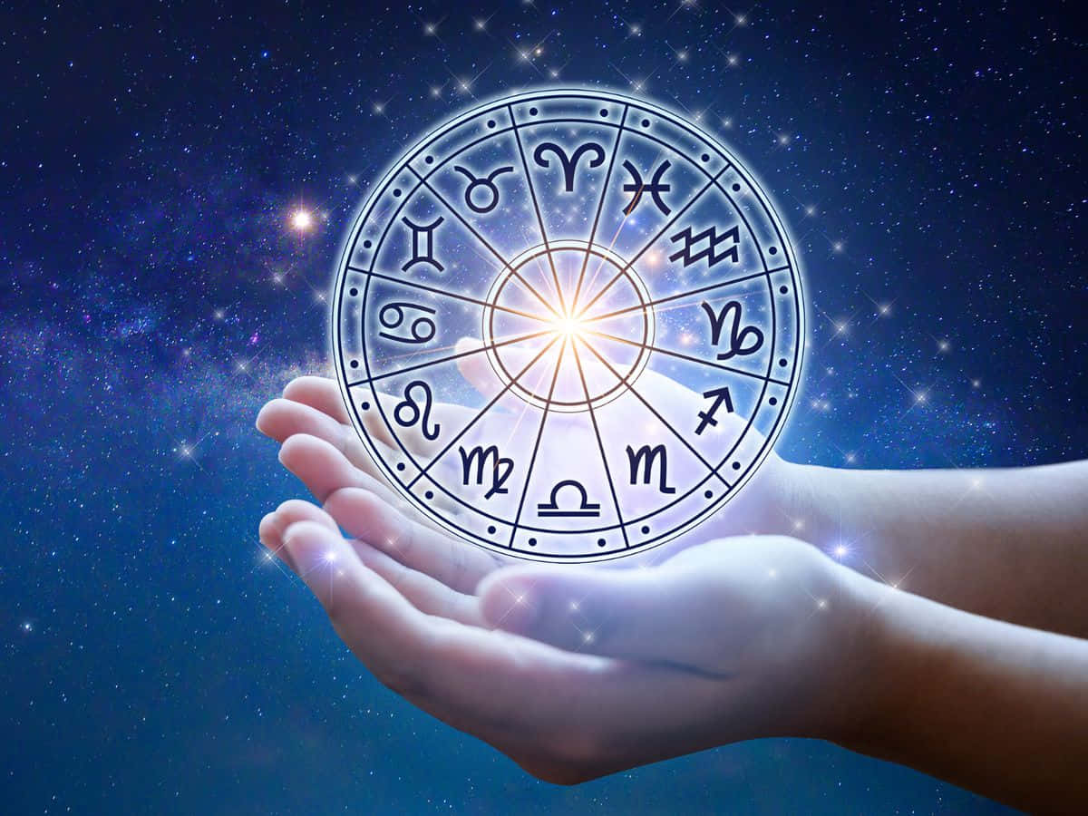 Zodiac Sign 桌布 壁紙 — 雙手捧著一個發光的星座輪盤，背景是星光燦爛的宇宙，光芒從輪盤中心四射。