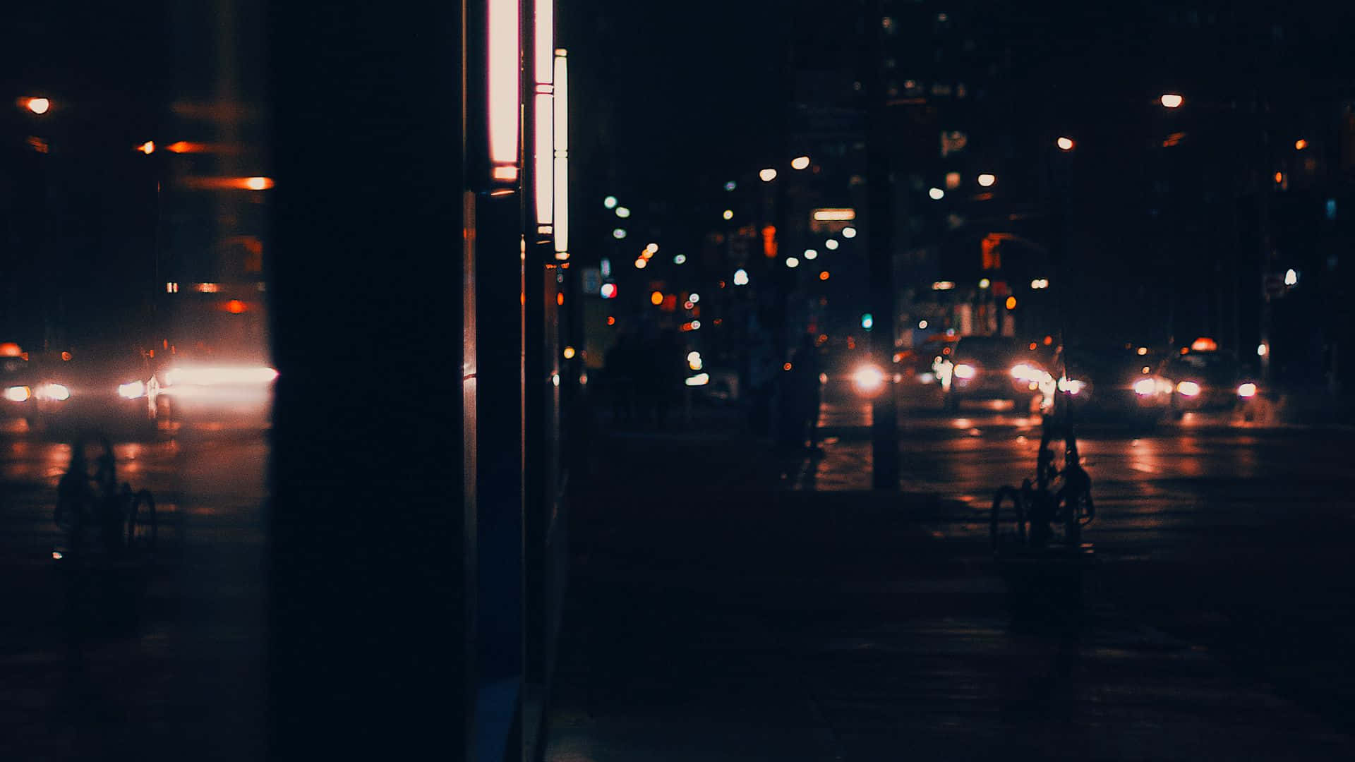 Night Street 桌布 壁紙 — 雨夜城市街道，車頭燈閃爍，霓虹燈在濕漉漉的路面上反射，畫面模糊。