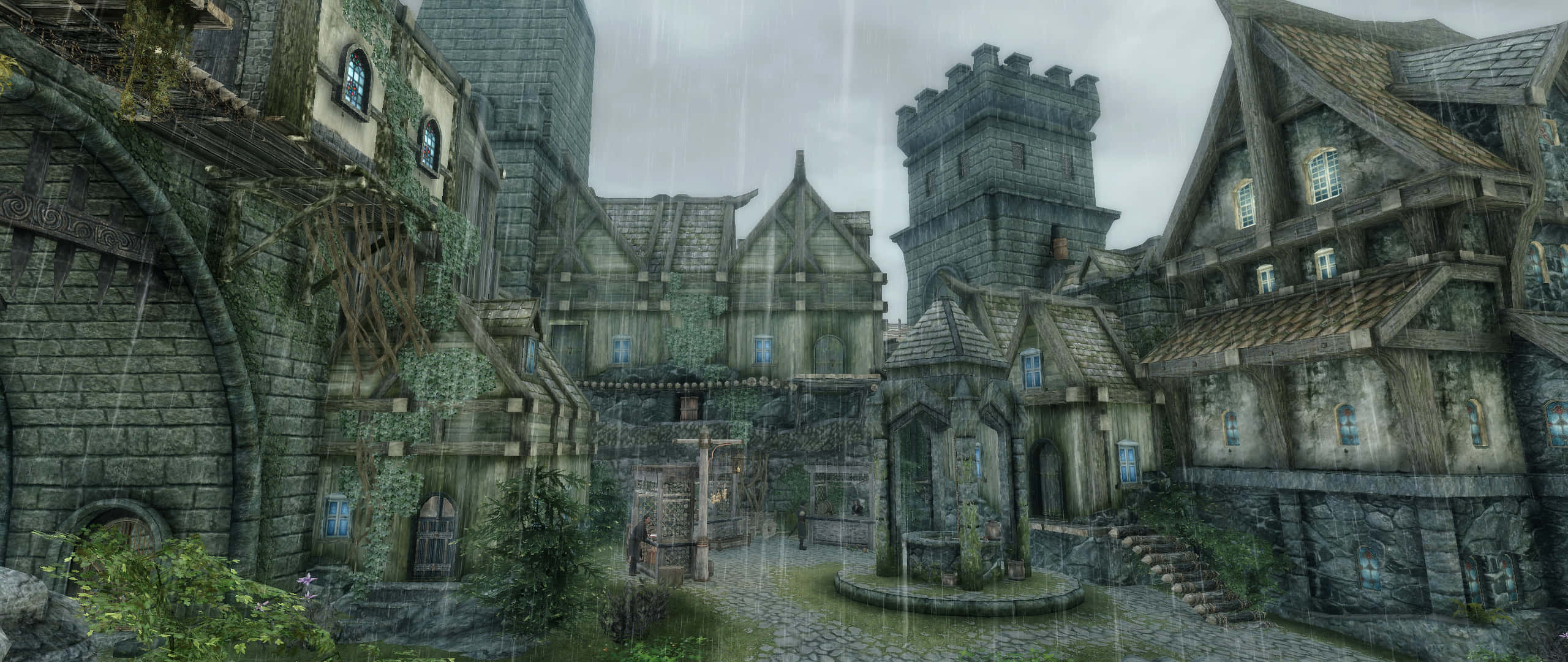 Skyrim Solitude 桌布 壁紙 — 雨水傾瀉在一個長滿苔蘚的中世紀村莊，村莊有石塔和木屋，天空灰濛濛。