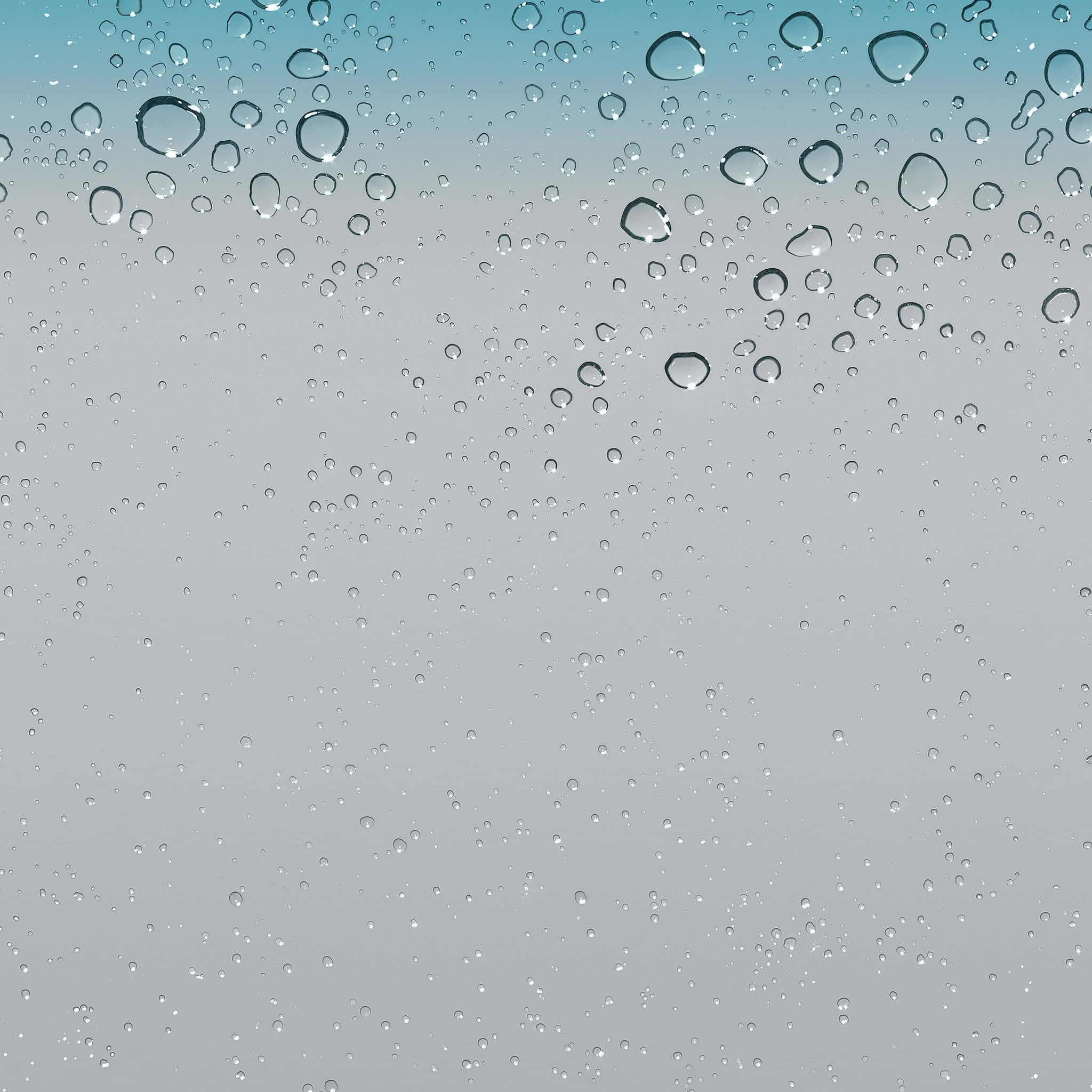iOS 4 桌布 壁紙 — 雨滴依附在窗玻璃上，背景是從藍綠色漸變到灰色的柔和天空。