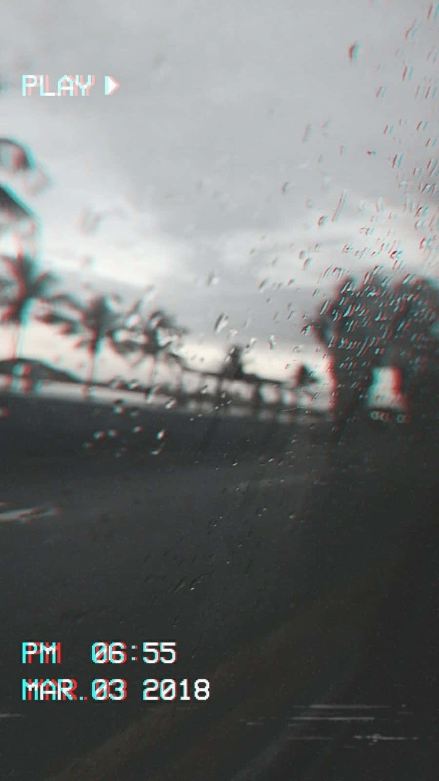 Aesthetic Rain 桌布 壁紙 — 雨滴劃過車窗，模糊的熱帶街道在陰天中掠過。