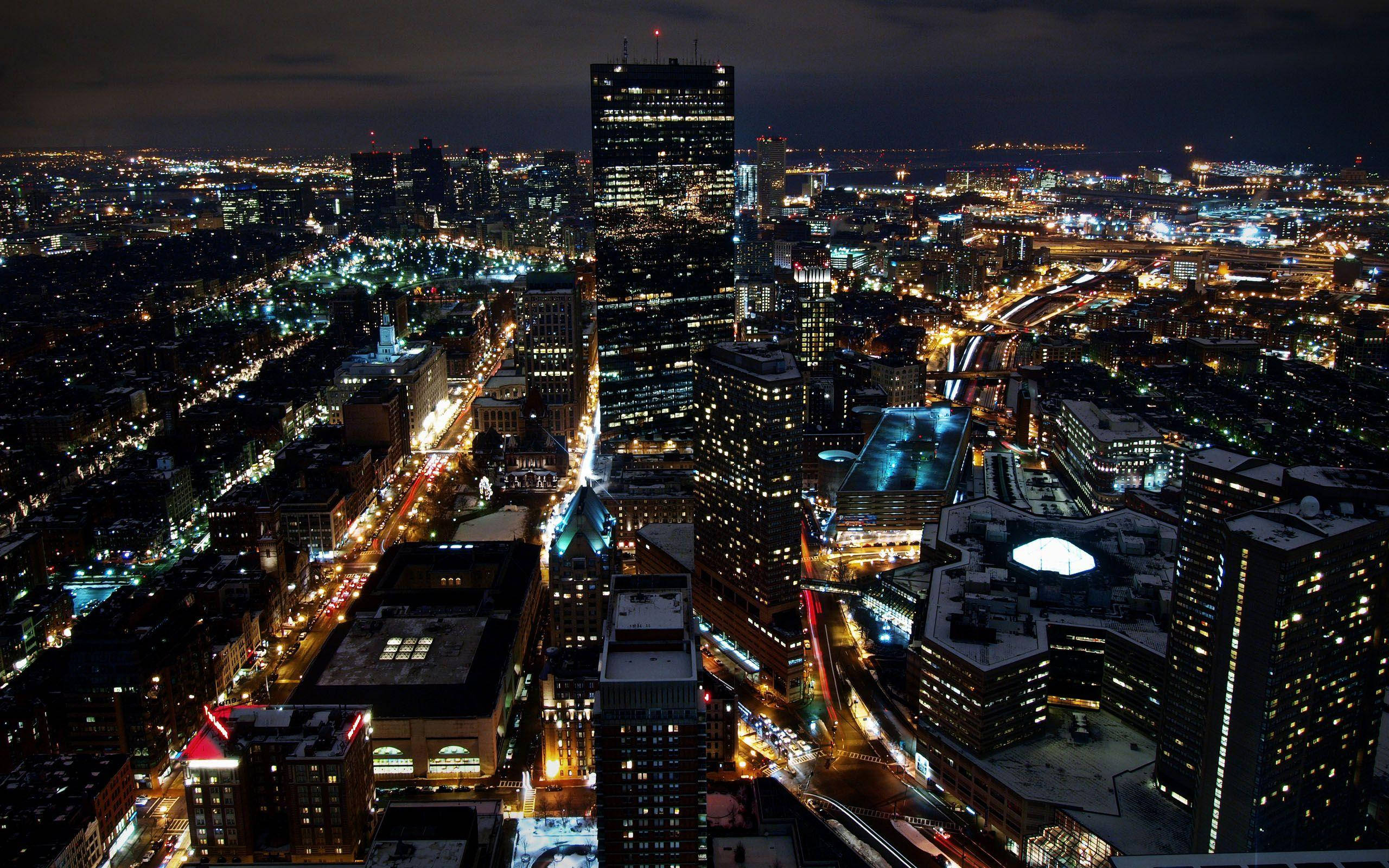 City Lights 桌布 壁紙 — 雪景城市夜景鳥瞰圖，高樓大廈燈火通明，街燈閃爍。