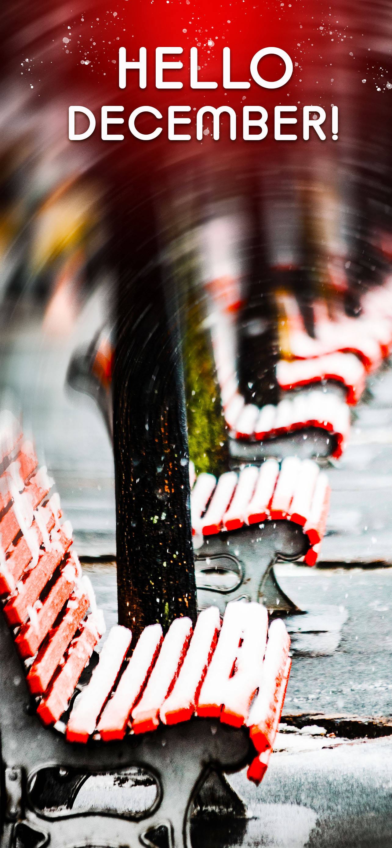 十二月 桌布 壁紙 — 雪花飄過一排紅色長椅，冬日城市場景，粗體文字寫著 hello december