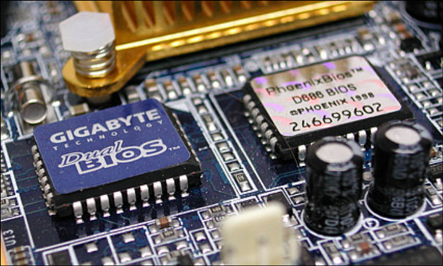 科技動圖 桌布 壁紙 — 電腦主機板特寫，顯示藍色Gigabyte Dual BIOS晶片和帶金色散熱片的Phoenix BIOS晶片。