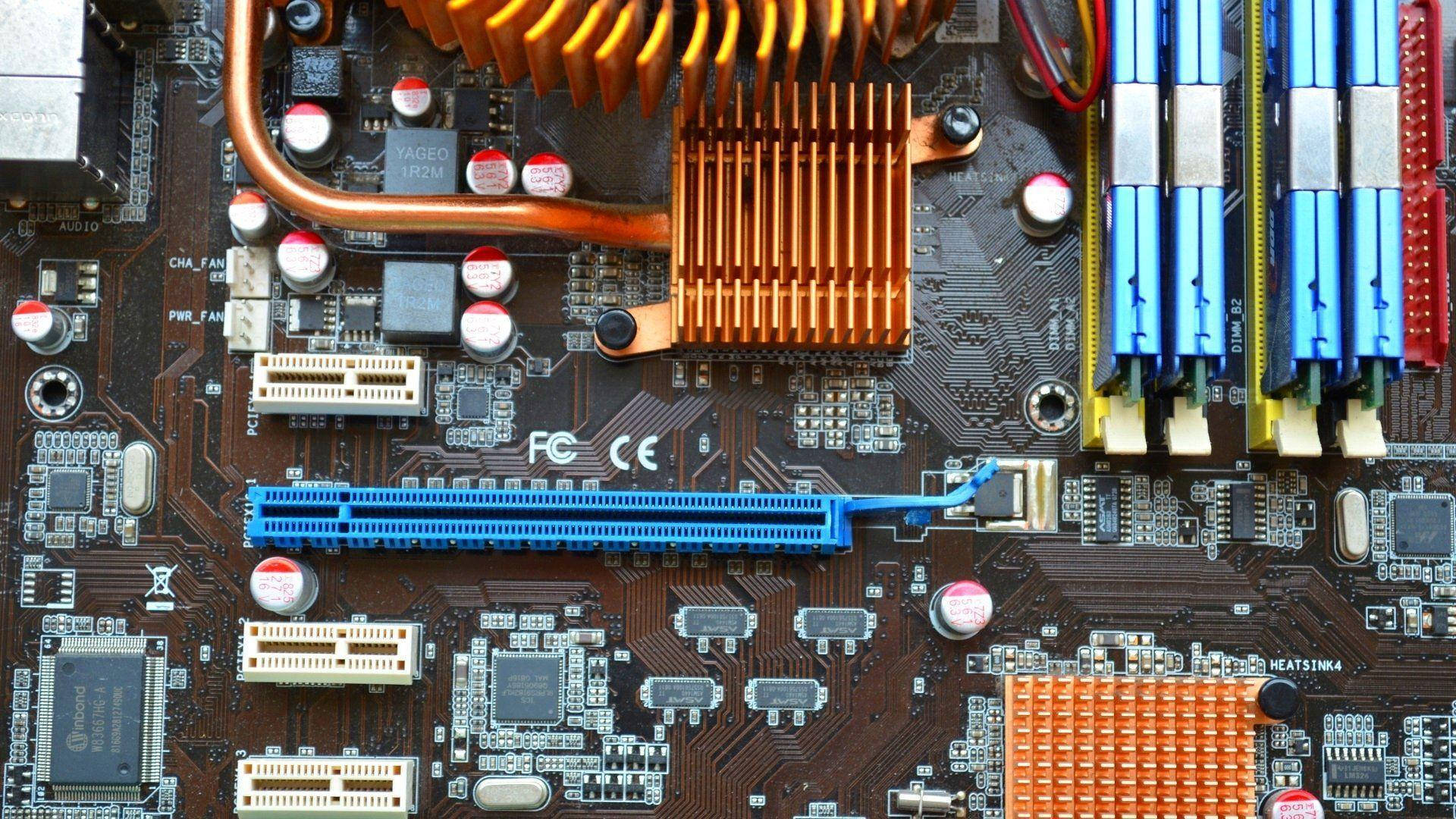 Motherboard 桌布 壁紙 — 電腦主機板特寫，顯示銅製散熱器、藍色RAM插槽和電路。
