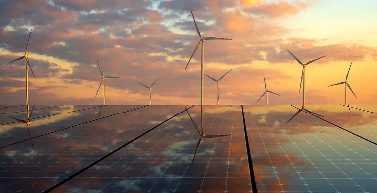 Renewable Energy 桌布 壁紙 — 風力渦輪機和太陽能板在未來主義能源景觀上方的 vibrant 日落天空中反射。