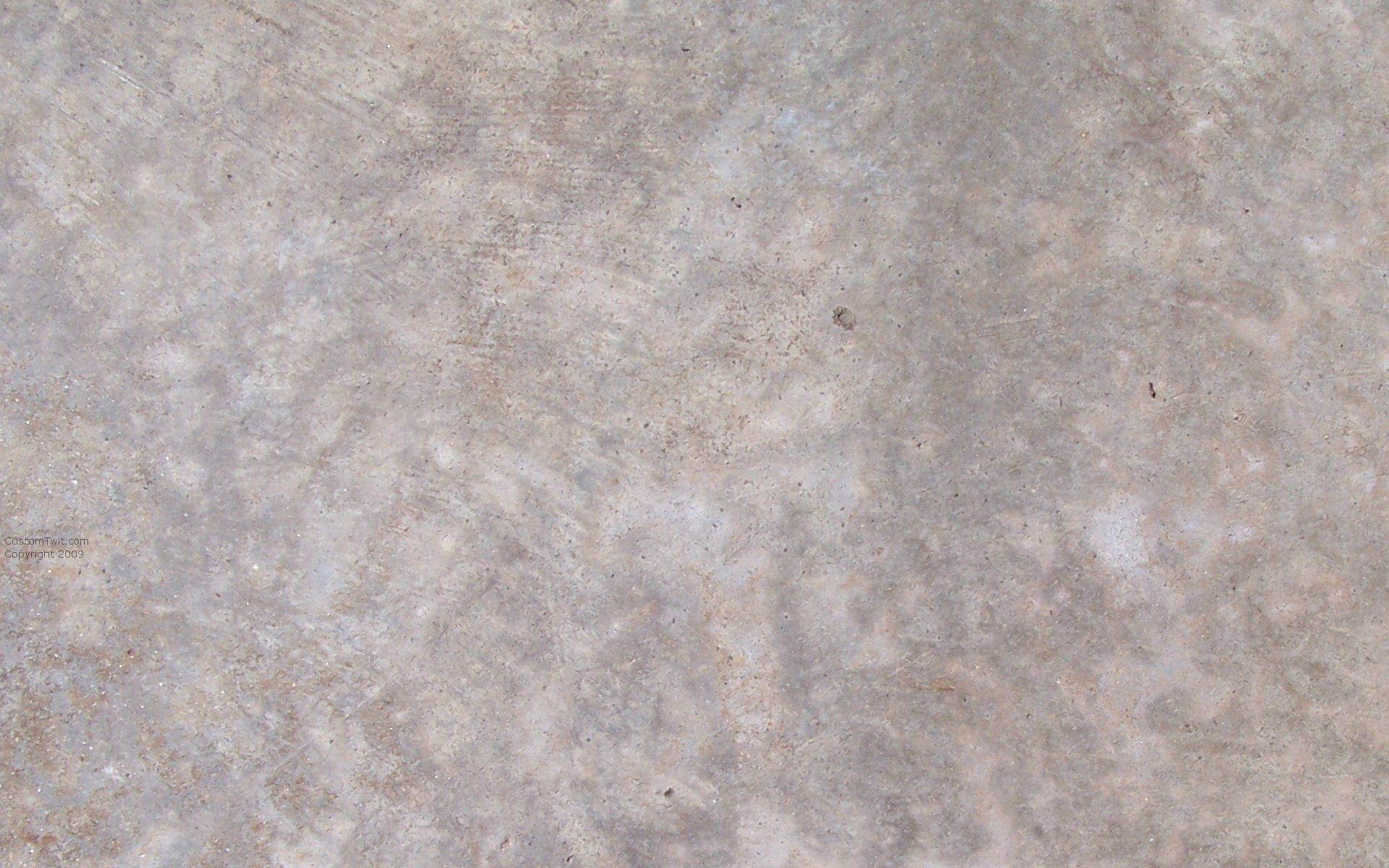 texture 桌布 壁紙 — 風化混凝土表面的特寫，帶有微妙的灰色和米色斑點以及微弱的刮痕。