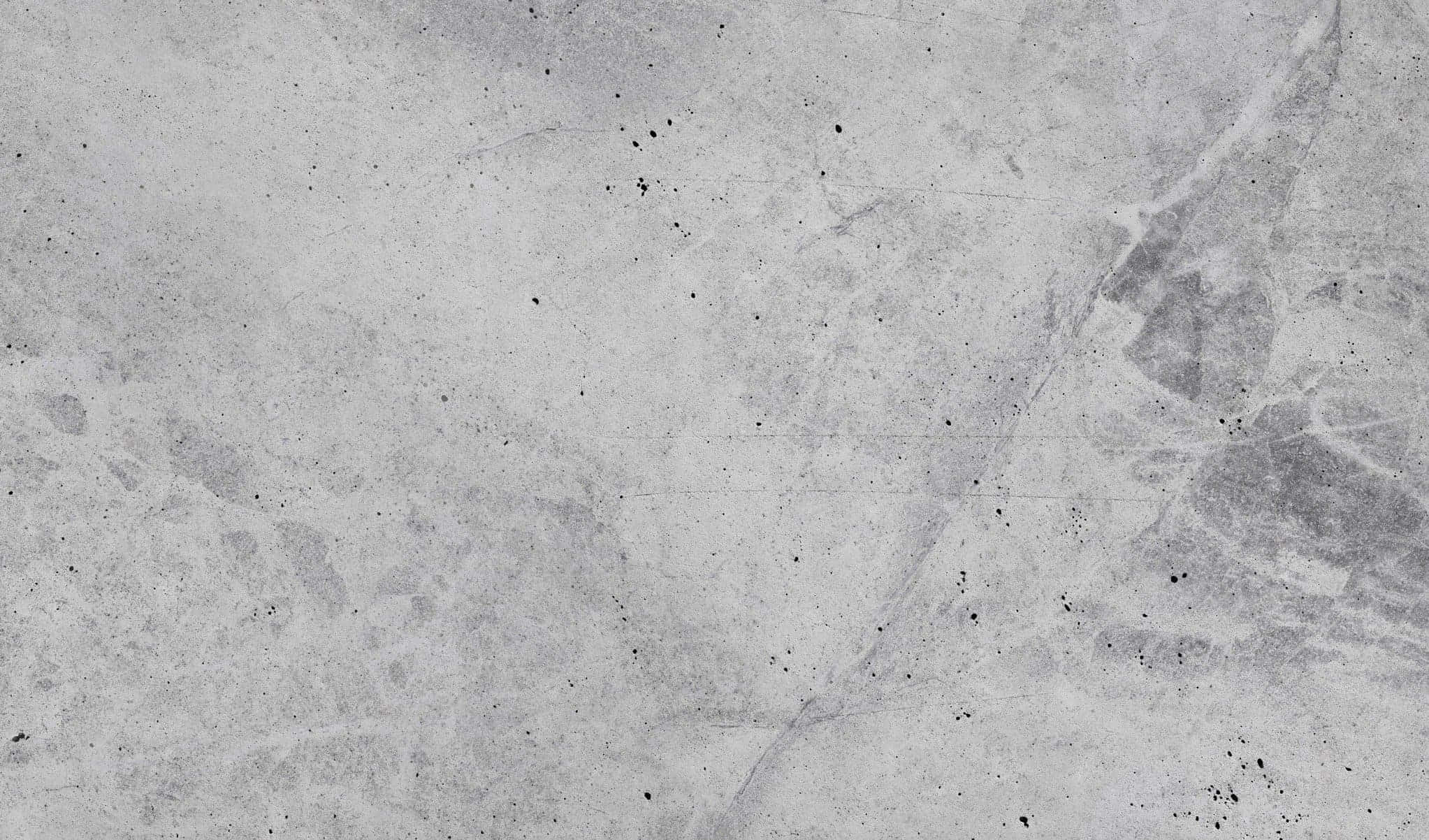 混凝土 桌布 壁紙 — 風化灰色混凝土的特寫，帶有細微裂縫和斑點，營造出原始工業質感。