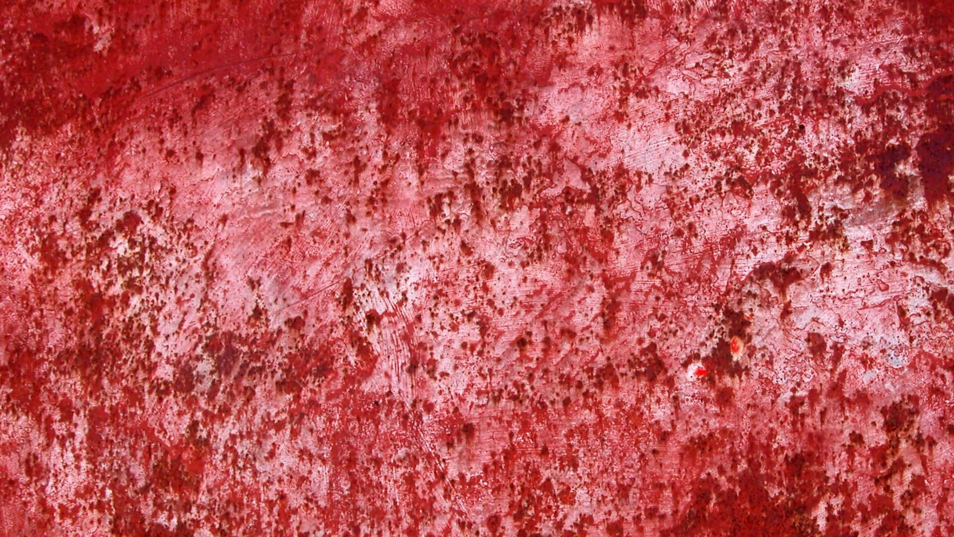 Red Texture 桌布 壁紙 — 風化紅色表面的特寫，帶有紋理刮痕和淺粉紅色及白色的斑點。