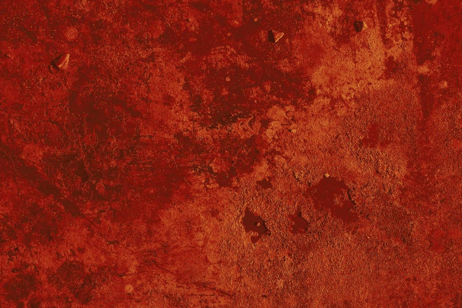 Red Texture 桌布 壁紙 — 風化鏽蝕金屬表面的特寫，帶有深紅和橙色色調以及散落的碎片。