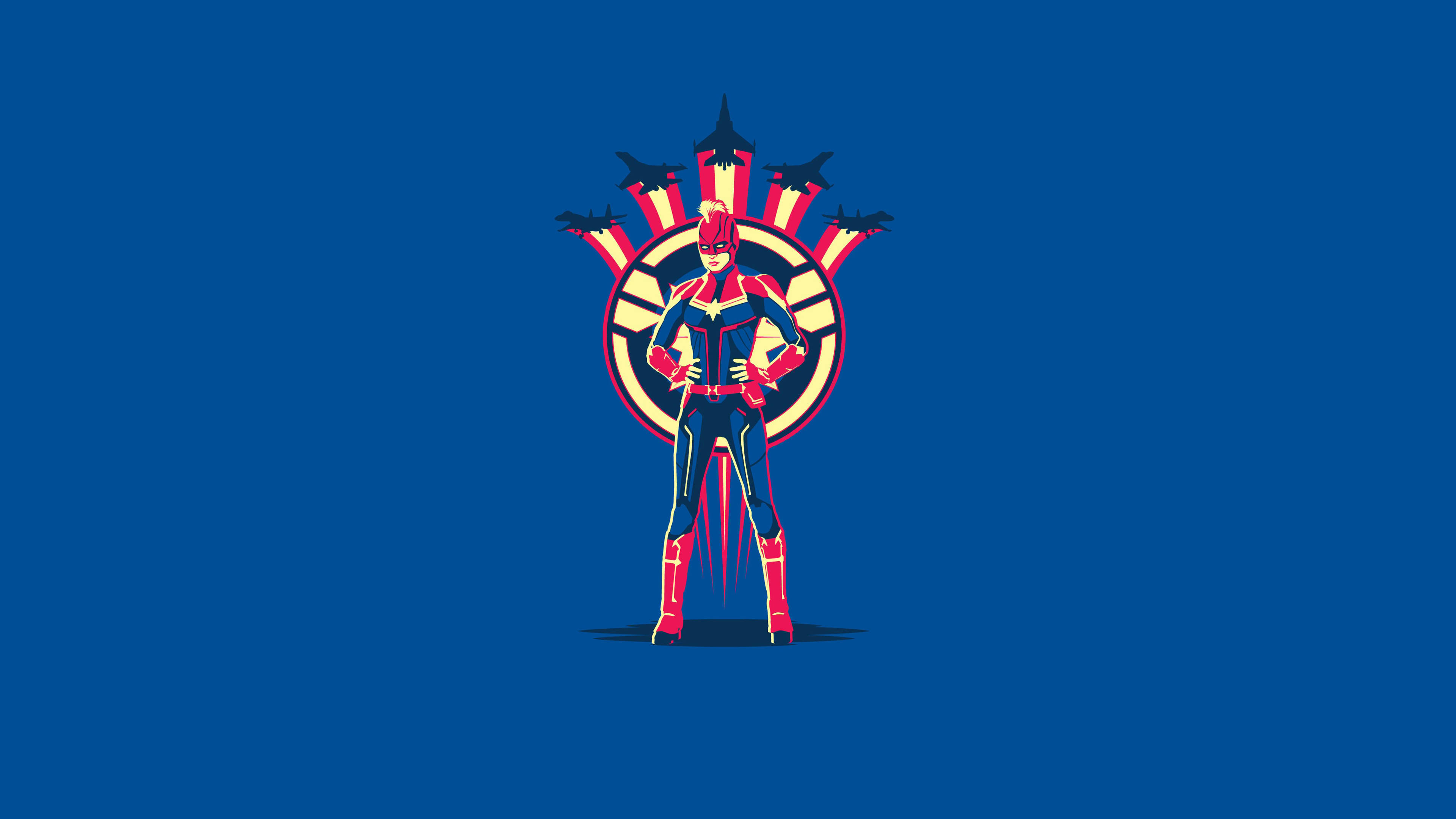 Marvel Minimalist 桌布 壁紙 — 驚奇隊長自信地穿著大膽的紅藍黃色套裝，站在純藍色背景前，戰鬥機在她身後形成圓形標誌。