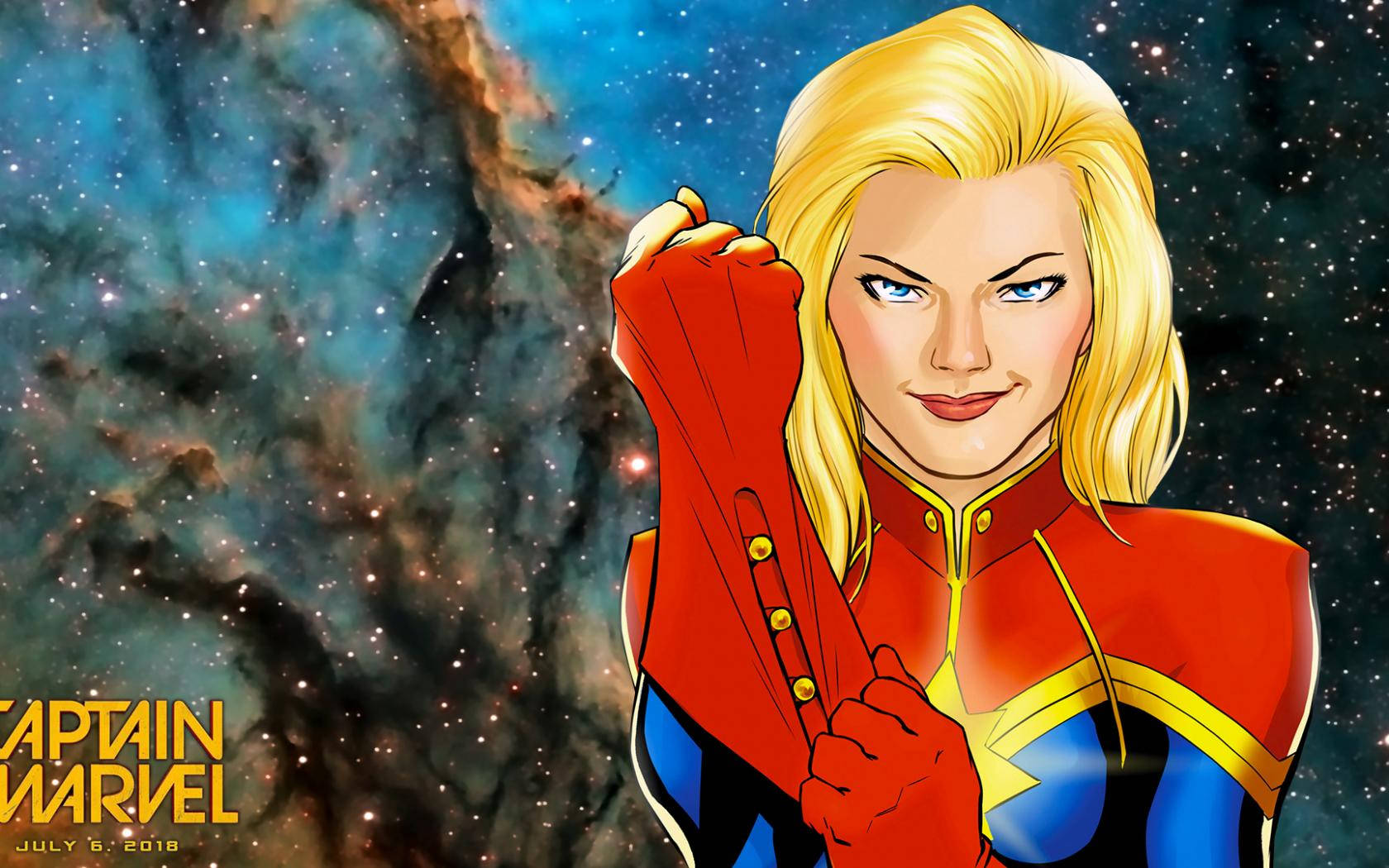 Captain Marvel 桌布 壁紙 — 驚奇隊長自信地穿著她的紅藍金色套裝，背景是充滿活力的宇宙星雲。