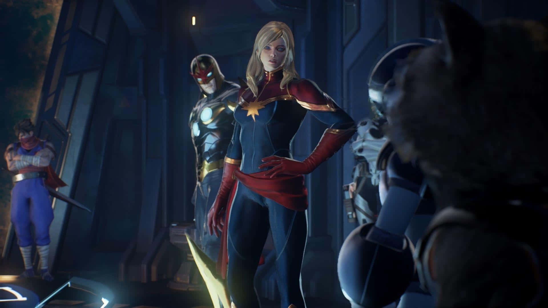 Captain Marvel HD 桌布 壁紙 — 驚奇隊長自信地站在一個昏暗的未來風格房間中，帶有發光的裝飾，其他英雄注視著她。