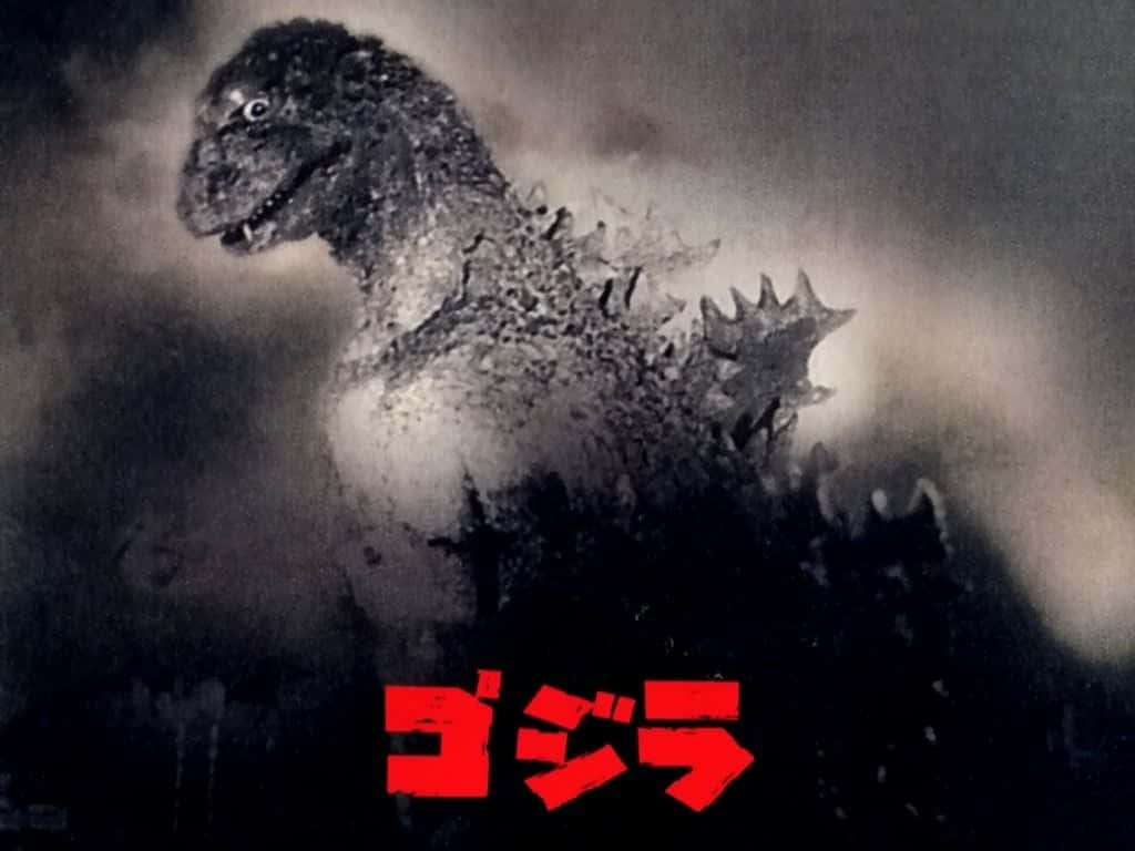 Godzilla 1954 桌布 壁紙 — 高聳的哥吉拉從煙霧中出現，眼睛發光，下方有紅色日文字。