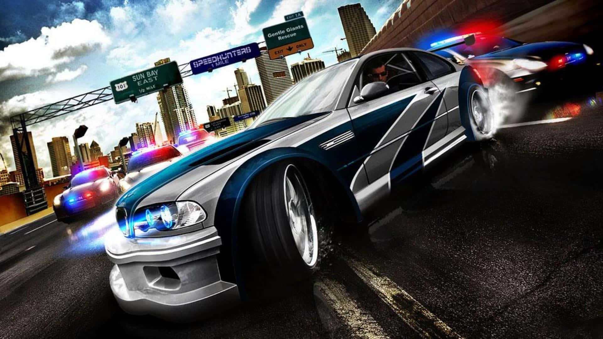 跑車 桌布 壁紙 — 高速警匪追逐在城市的公路上展開，伴隨著閃爍的燈光和模糊的動態，以天際線為背景。