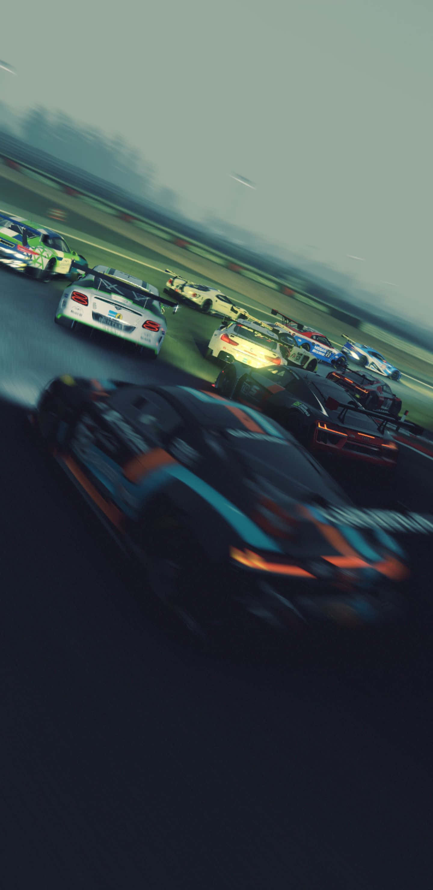 Pixel 3xl Project Cars 2 桌布 壁紙 — 高速賽車在陰天下濕滑賽道上飛馳的動態模糊效果。