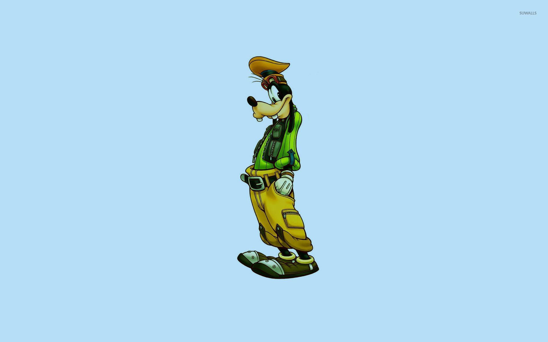 Goofy 桌布 壁紙 — 高飛自信地站立，身穿綠色背心和黃色褲子，背景為純淺藍色。
