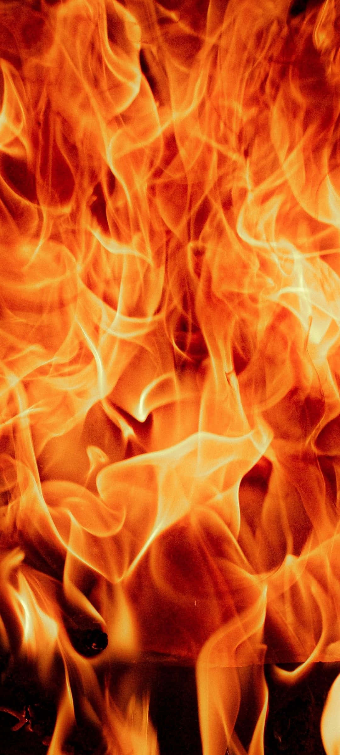 Flame 桌布 壁紙 — 鮮明特寫：在深色背景下，舞動的橙色和黃色火焰與發光的餘燼。