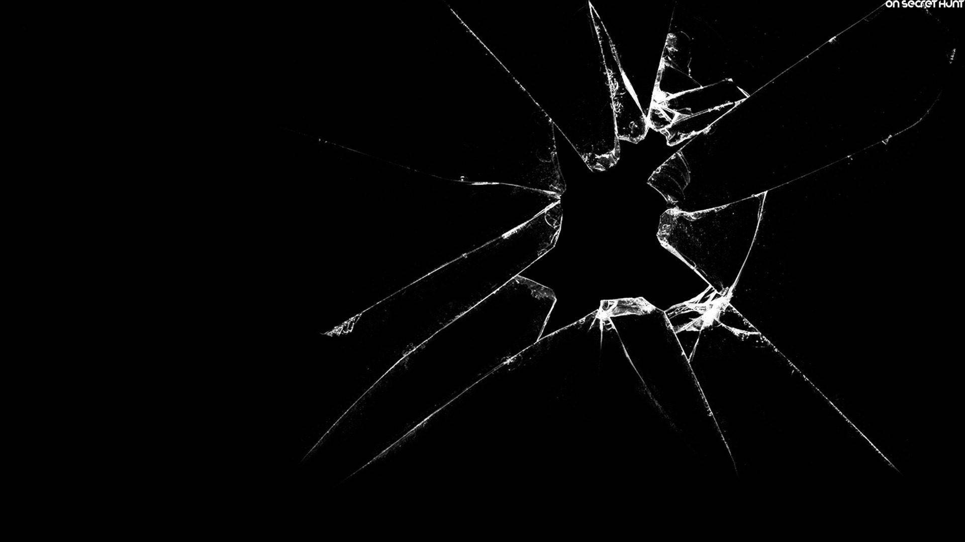 cracked 桌布 壁紙 — 鮮明的黑色背景，中央有白色發光的碎玻璃碎片星爆。