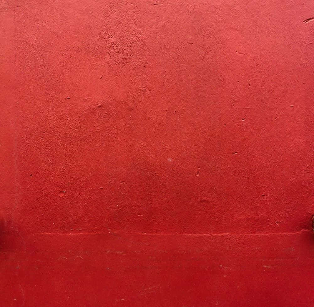 Dark Red Aesthetic 桌布 壁紙 — 鮮紅色油漆牆壁的特寫，可見紋理和細微瑕疵。