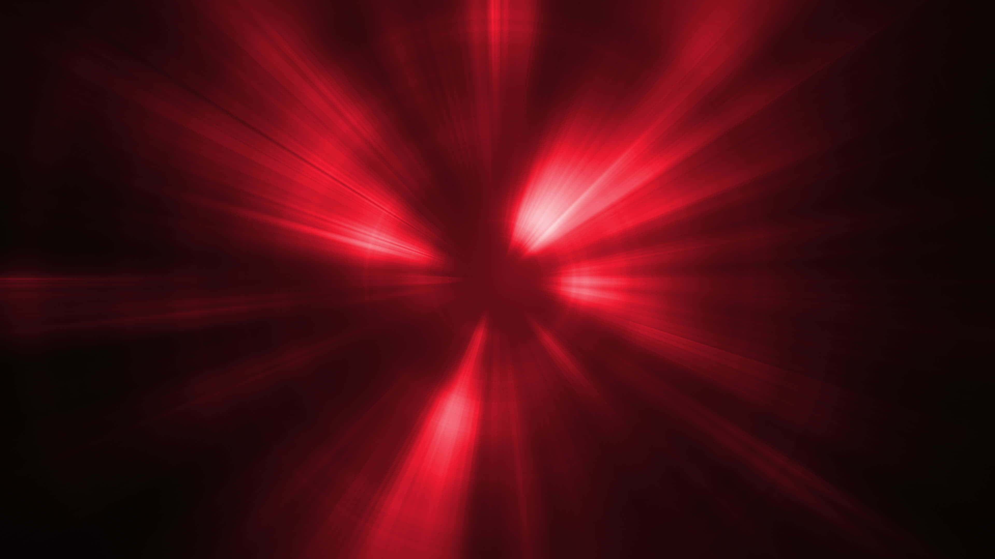 Red Light 桌布 壁紙 — 鮮紅色的光線從中心點迸發，在深黑色背景上營造出戲劇性的輻射效果。