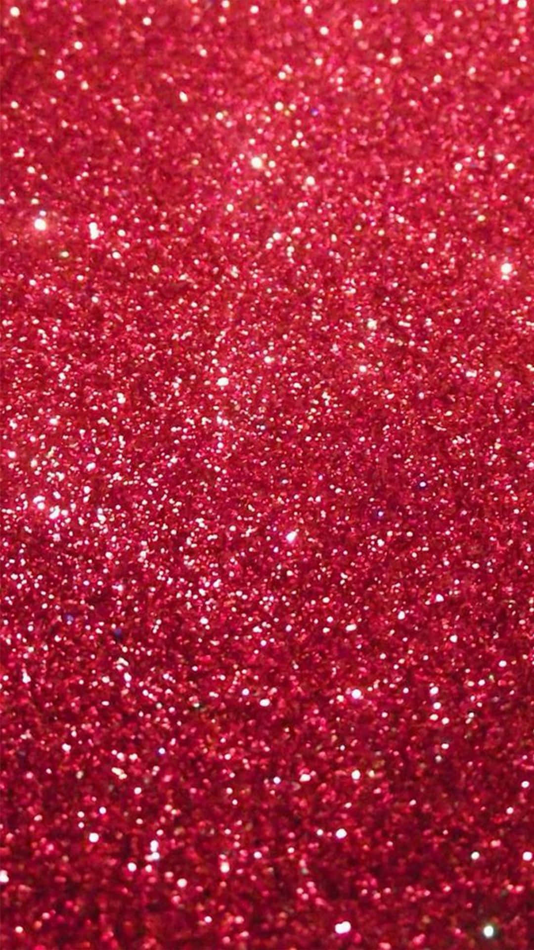 Red Glitter 桌布 壁紙 — 鮮紅色閃粉的特寫，閃爍的顆粒在整個畫面中捕捉光線。
