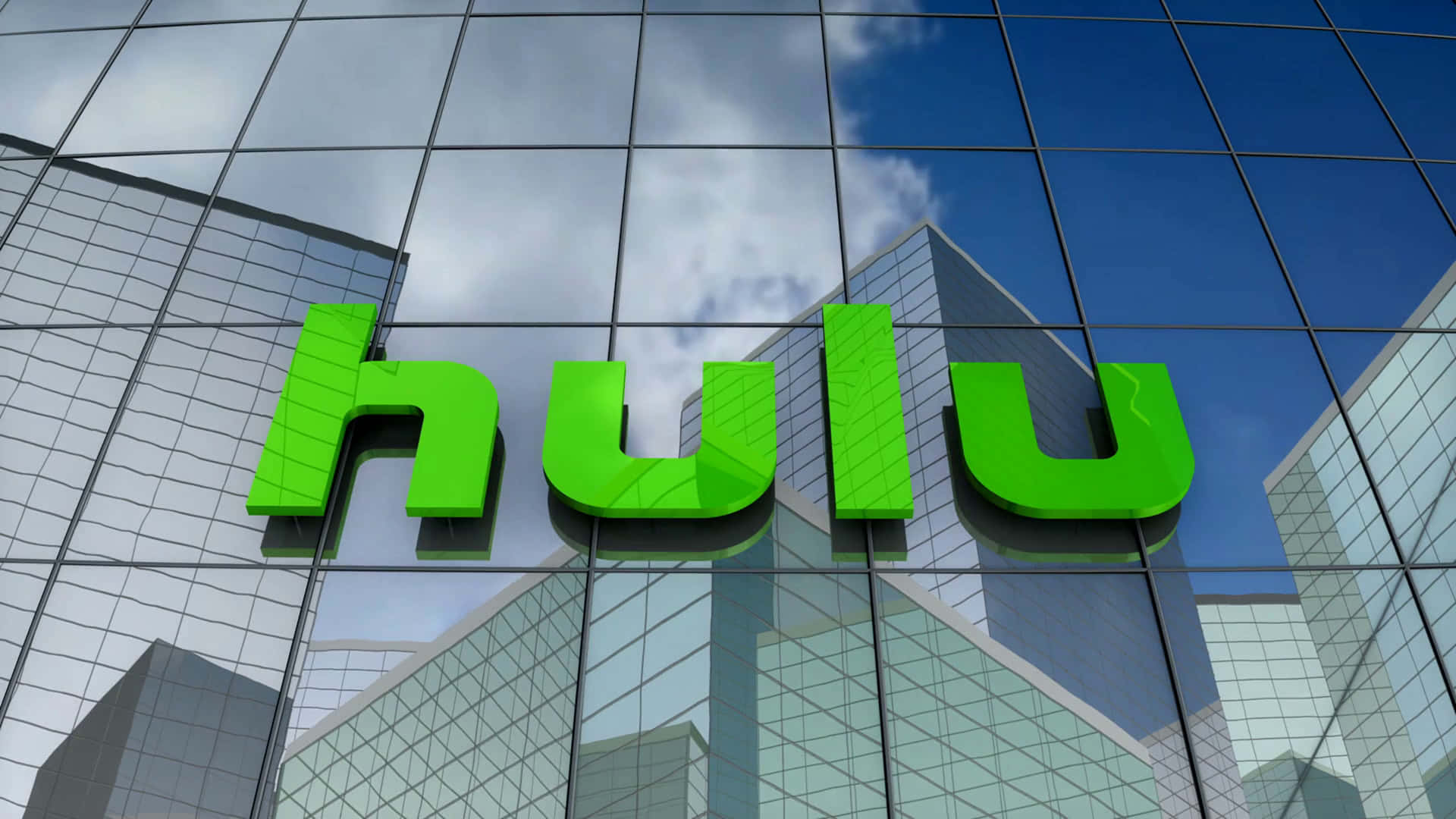 Hulu 桌布 壁紙 — 鮮綠色Hulu標誌安裝在玻璃摩天大樓上，反射藍天白雲。