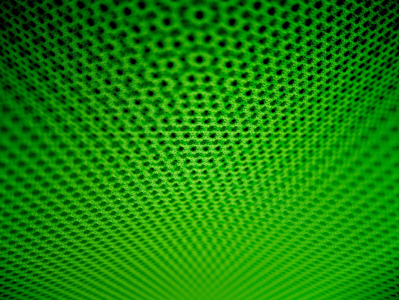 Halftone 桌布 壁紙 — 鮮綠色網狀布料的特寫，帶有徑向漸變和六邊形圖案。