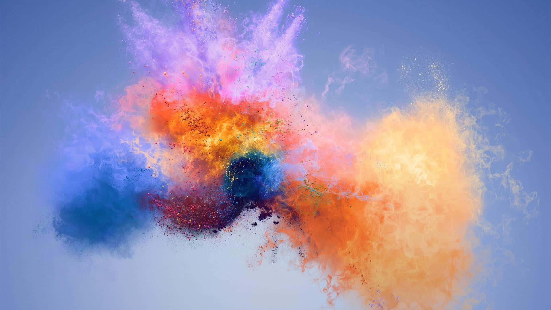 Colorful Smoke 桌布 壁紙 — 鮮豔多彩的粉末在清澈的藍天背景下動態爆炸，形成令人驚嘆的抽象爆發。