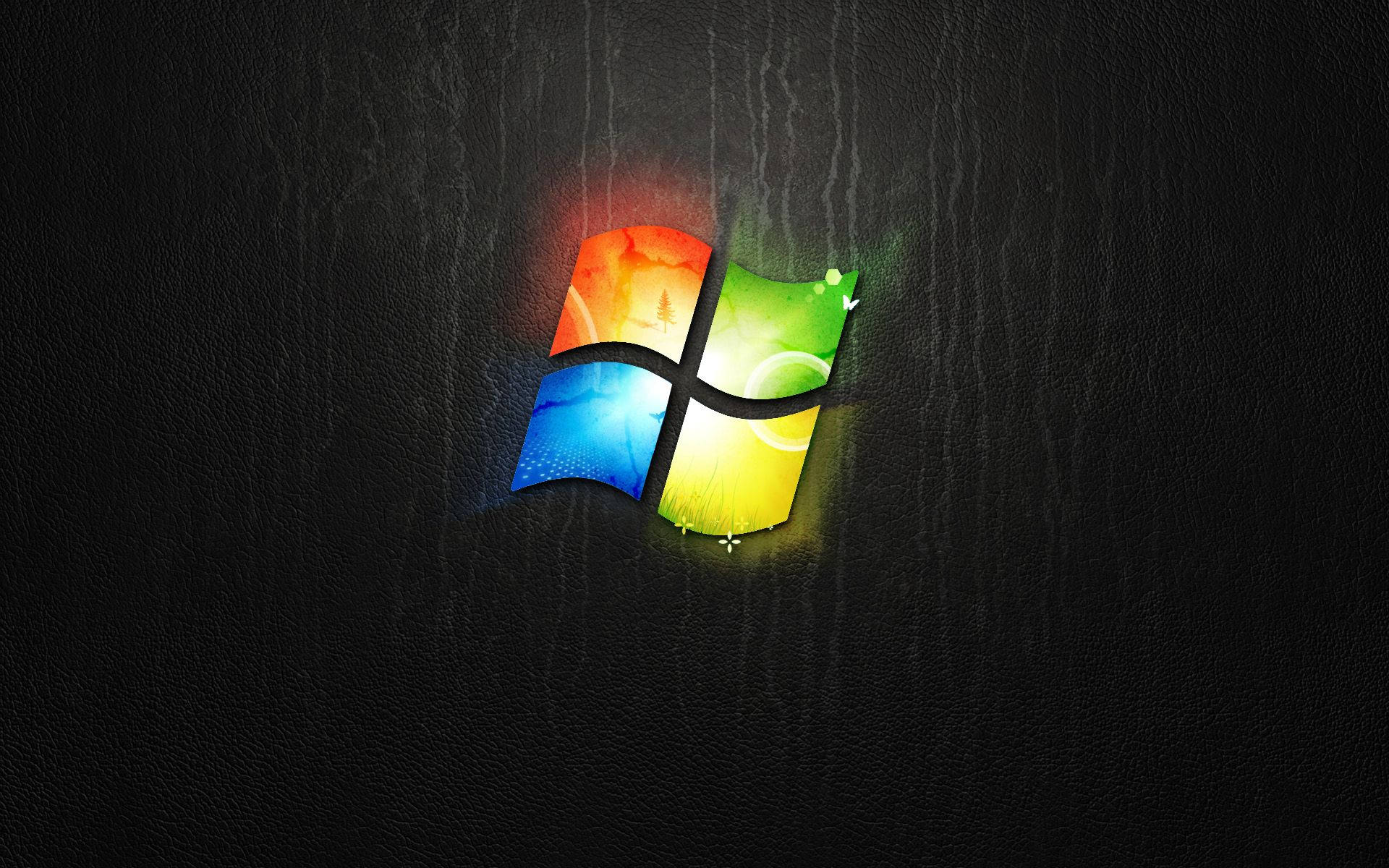 Windows 桌布 壁紙 — 鮮豔的Windows標誌在深色紋理皮革背景上發出彩虹色光芒。