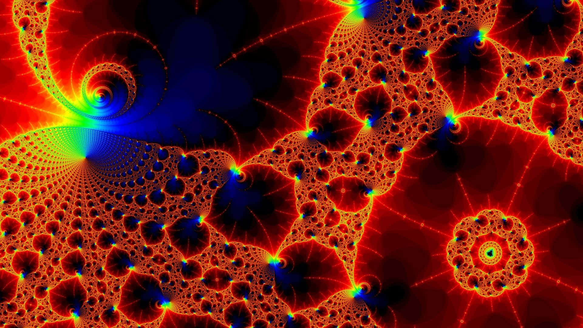 Trippy Fractals 桌布 壁紙 — 鮮豔的分形圖案在火紅和電光藍中旋轉，映襯著黑暗虛空，散發著複雜的幾何細節光芒。