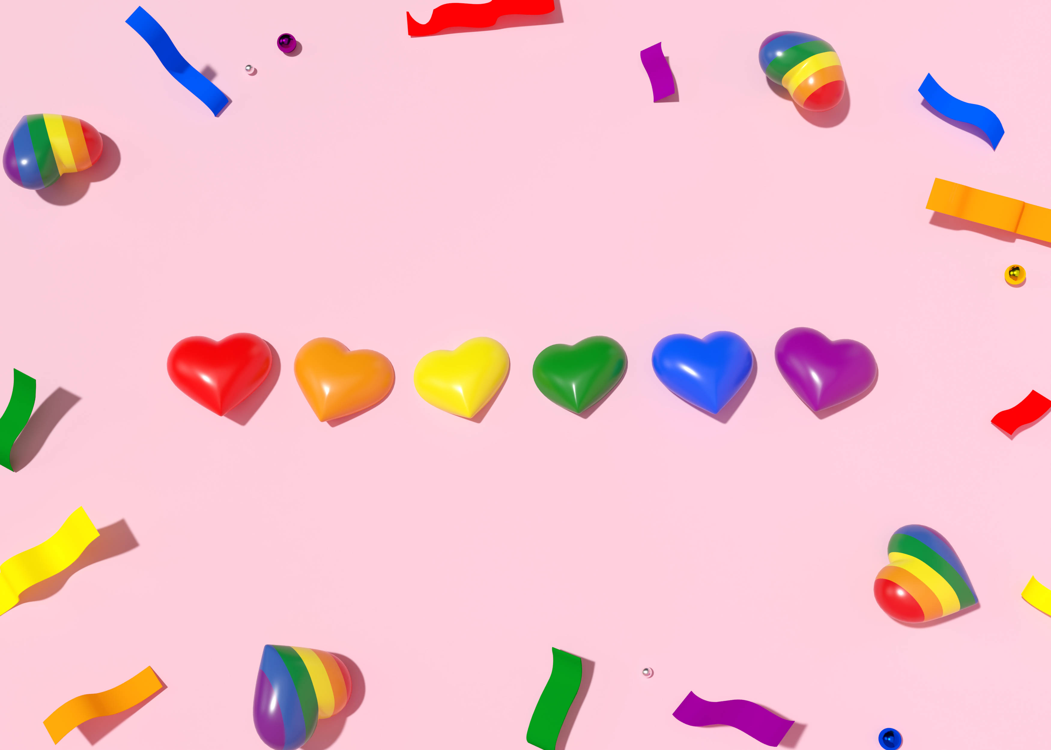 Aesthetic Heart 桌布 壁紙 — 鮮豔的彩虹心形和五彩紙屑散落在柔和的粉紅色背景上，構成一個俏皮的平面佈局。