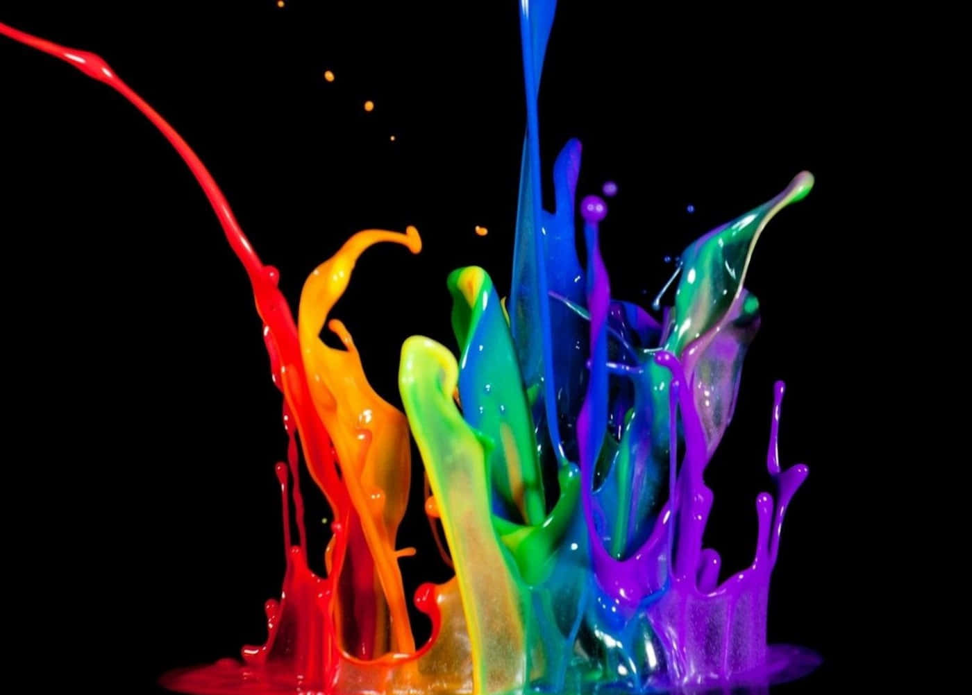paint 桌布 壁紙 — 鮮豔的彩虹顏料飛濺在漆黑的背景上動態爆炸，形成凝固的色彩爆發。
