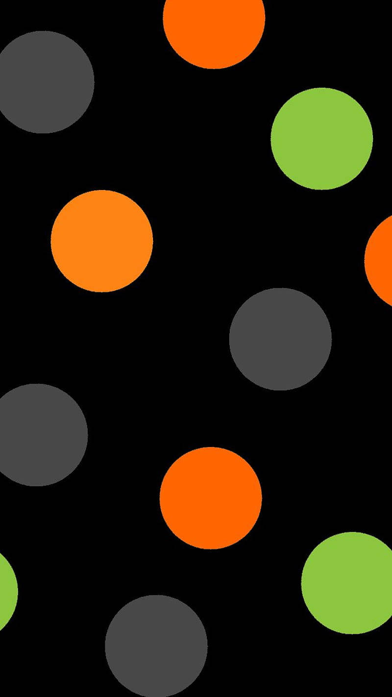 Dot 桌布 壁紙 — 鮮豔的橙色和萊姆綠色圓圈在純黑色背景上以俏皮的散落圖案漂浮。