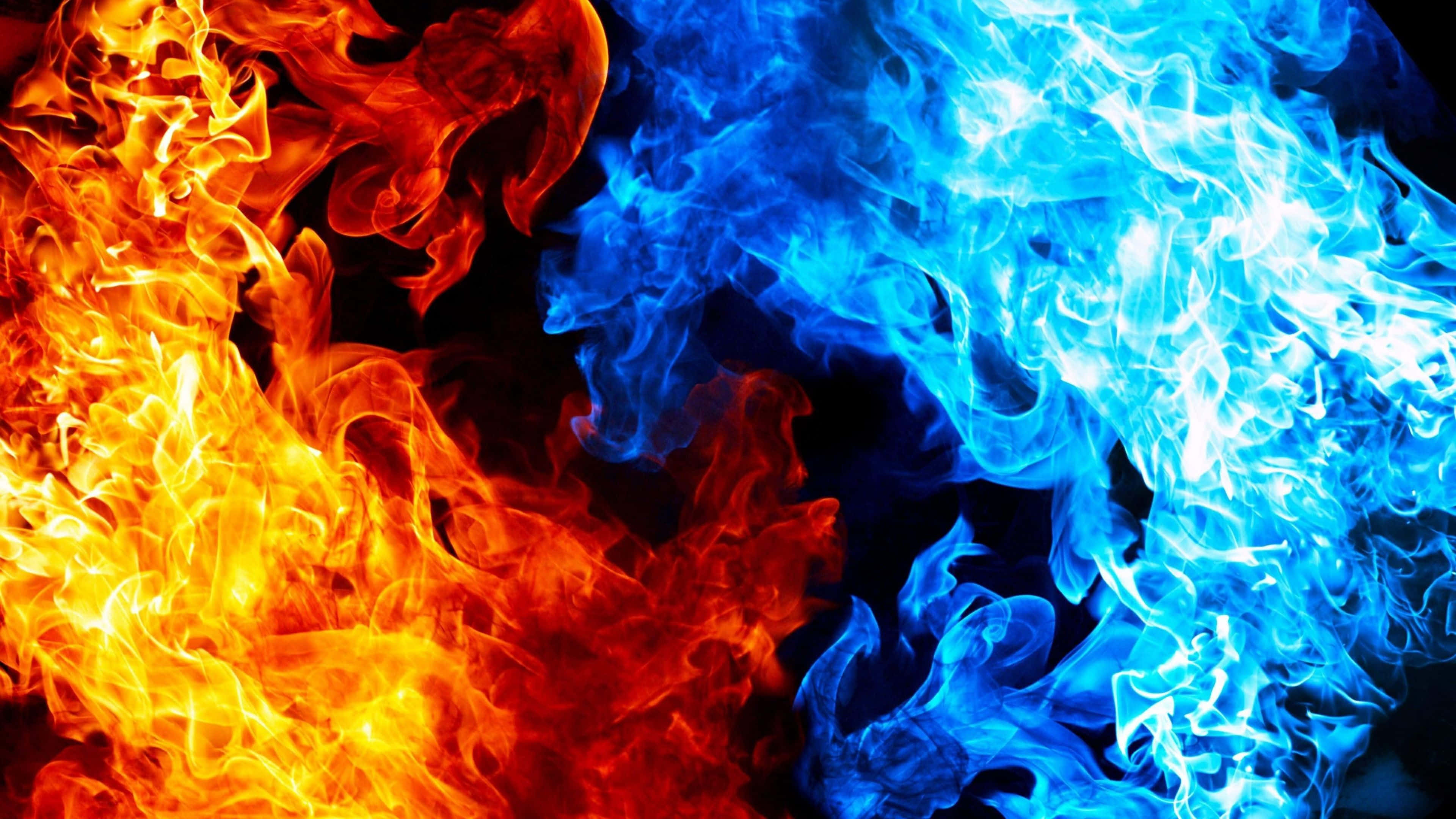 Flames 桌布 壁紙 — 鮮豔的橙色和藍色火焰在黑色背景上動態旋轉，營造出戲劇性的元素對比。