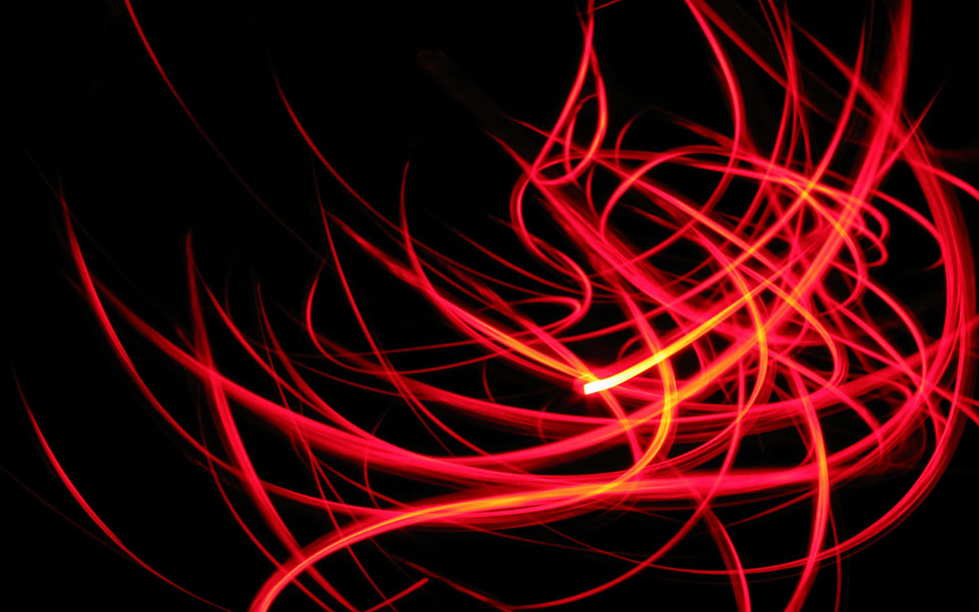Red Neon 桌布 壁紙 — 鮮豔的紅色光軌在純黑色背景上動態旋轉，形成迷人的抽象圖案。
