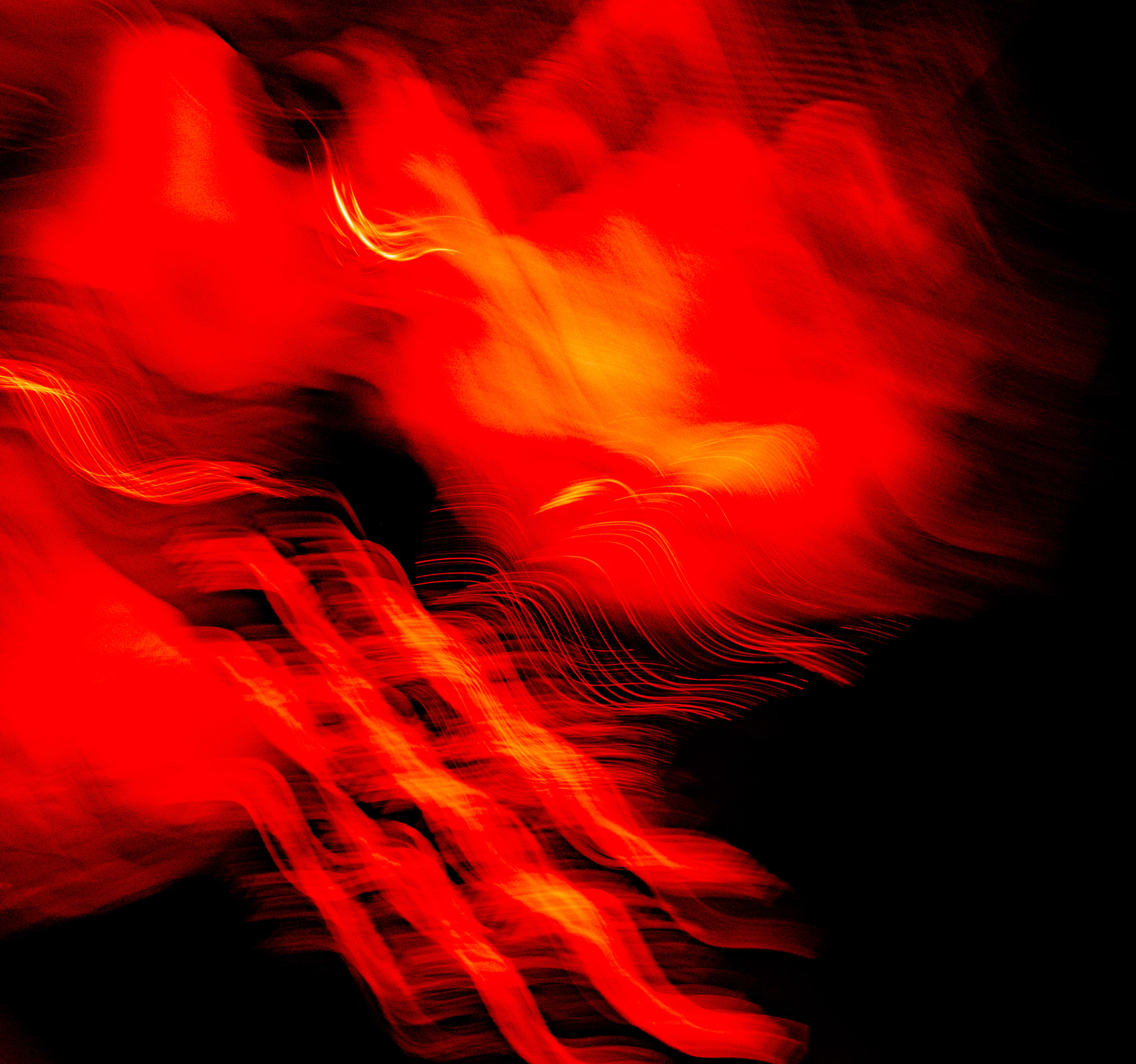 Red Light 桌布 壁紙 — 鮮豔的紅色和橙色光軌在深黑色背景上動態旋轉，營造出充滿活力的抽象運動效果。