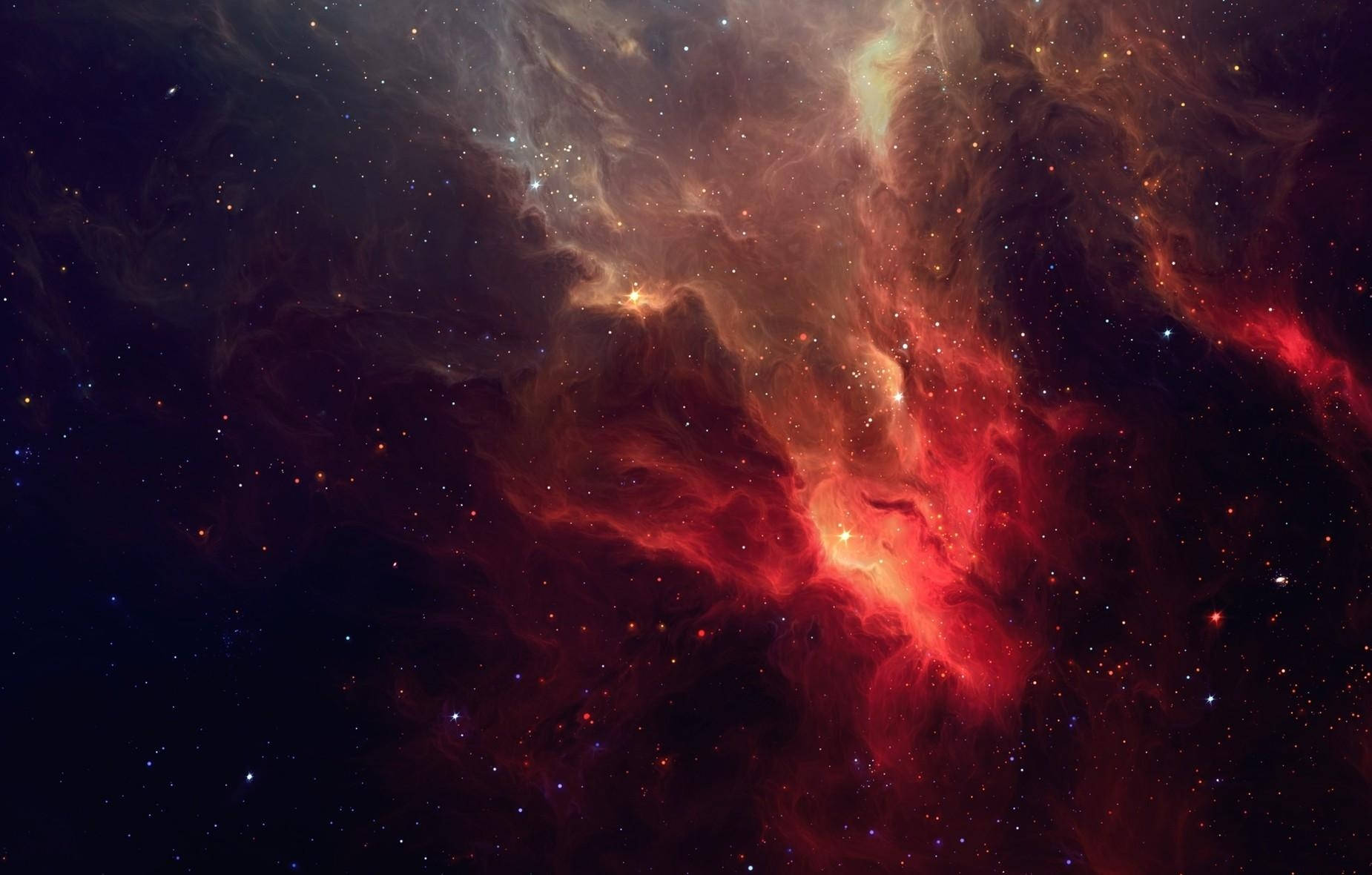 一個色彩繽紛的星雲，有紅色和橙色的雲朵以及散落的星星在深空中。 — 星雲 GIF 壁紙