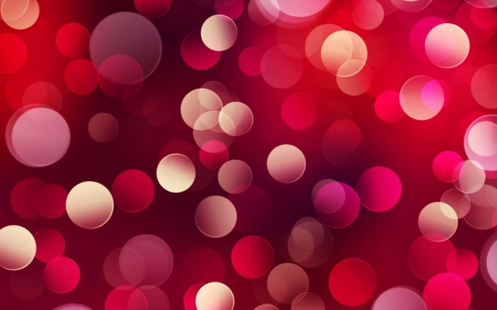 Screen 桌布 壁紙 — 鮮豔的紅色和粉紅色散景圓圈在深紅色的背景上柔和地發光，營造出夢幻般的抽象光效。