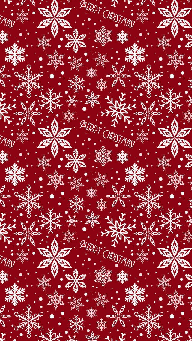 可愛聖誕 iPhone 桌布 壁紙 — 鮮豔的紅色壁紙，飾有精緻的白色雪花和散落的「聖誕快樂」文字。