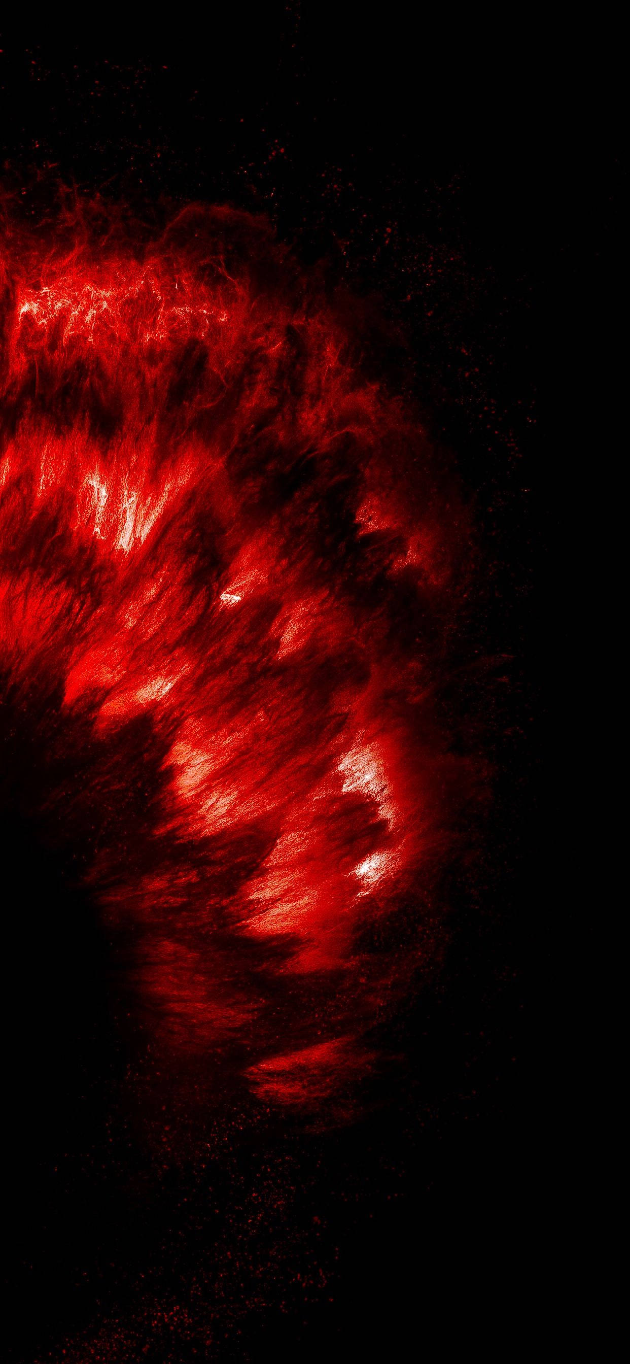 iPhone 桌布 壁紙 — 鮮豔的紅色宇宙星雲在漆黑虛空中旋轉，帶有發光的絲狀物和散落的粒子。