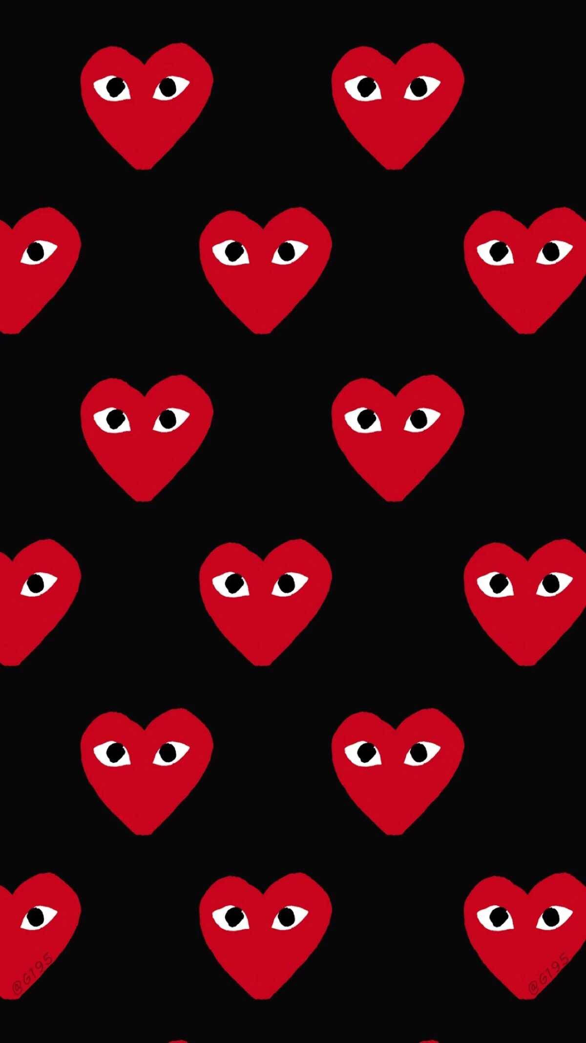 cdg 桌布 壁紙 — 鮮豔的紅色心形帶有卡通眼睛，在純黑背景上以網格重複排列。