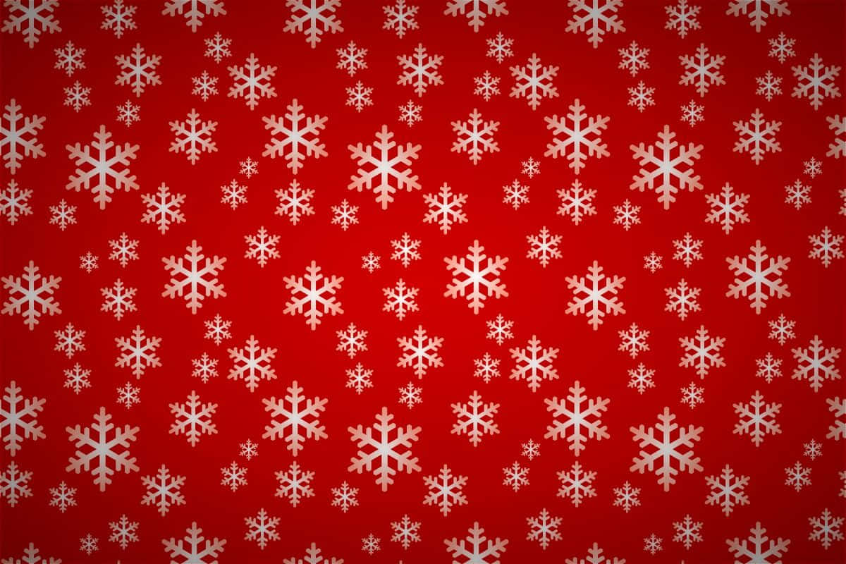 Christmas Pattern 桌布 壁紙 — 鮮豔的紅色背景上點綴著散落的白色雪花，大小不一，營造出節日喜慶的圖案。
