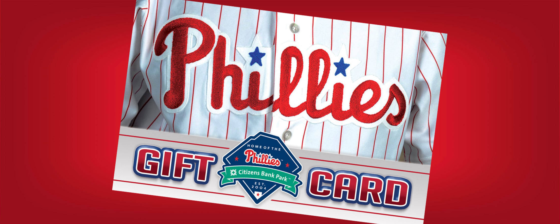 Phillies 桌布 壁紙 — 鮮豔的紅色背景展示了一張費城費城人隊棒球禮品卡，帶有球隊標誌和細條紋球衣設計。
